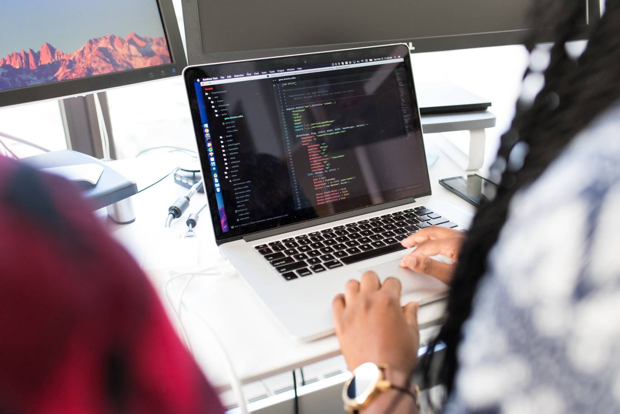 Lady working on development codes on laptop