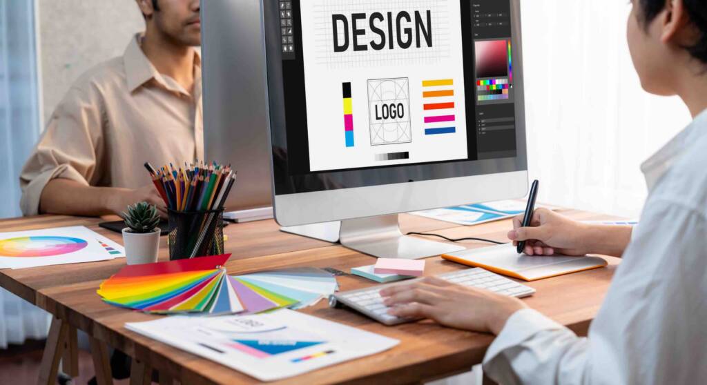 A designer working on a logo design on a computer