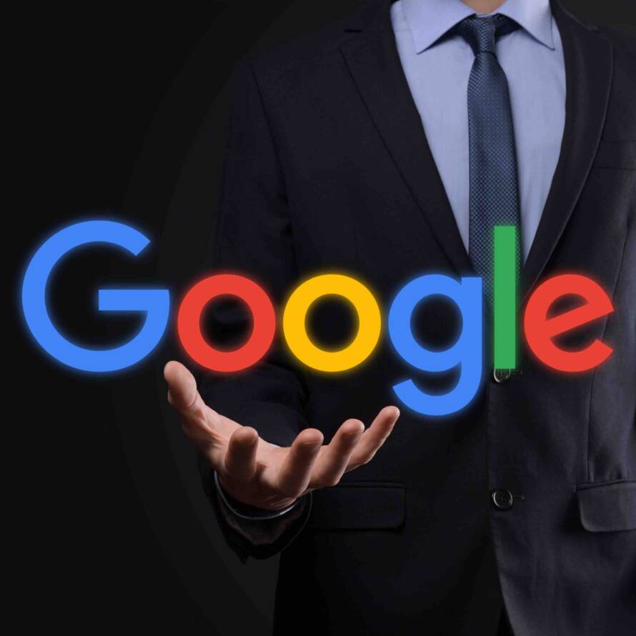 A person in suit holding the text Google