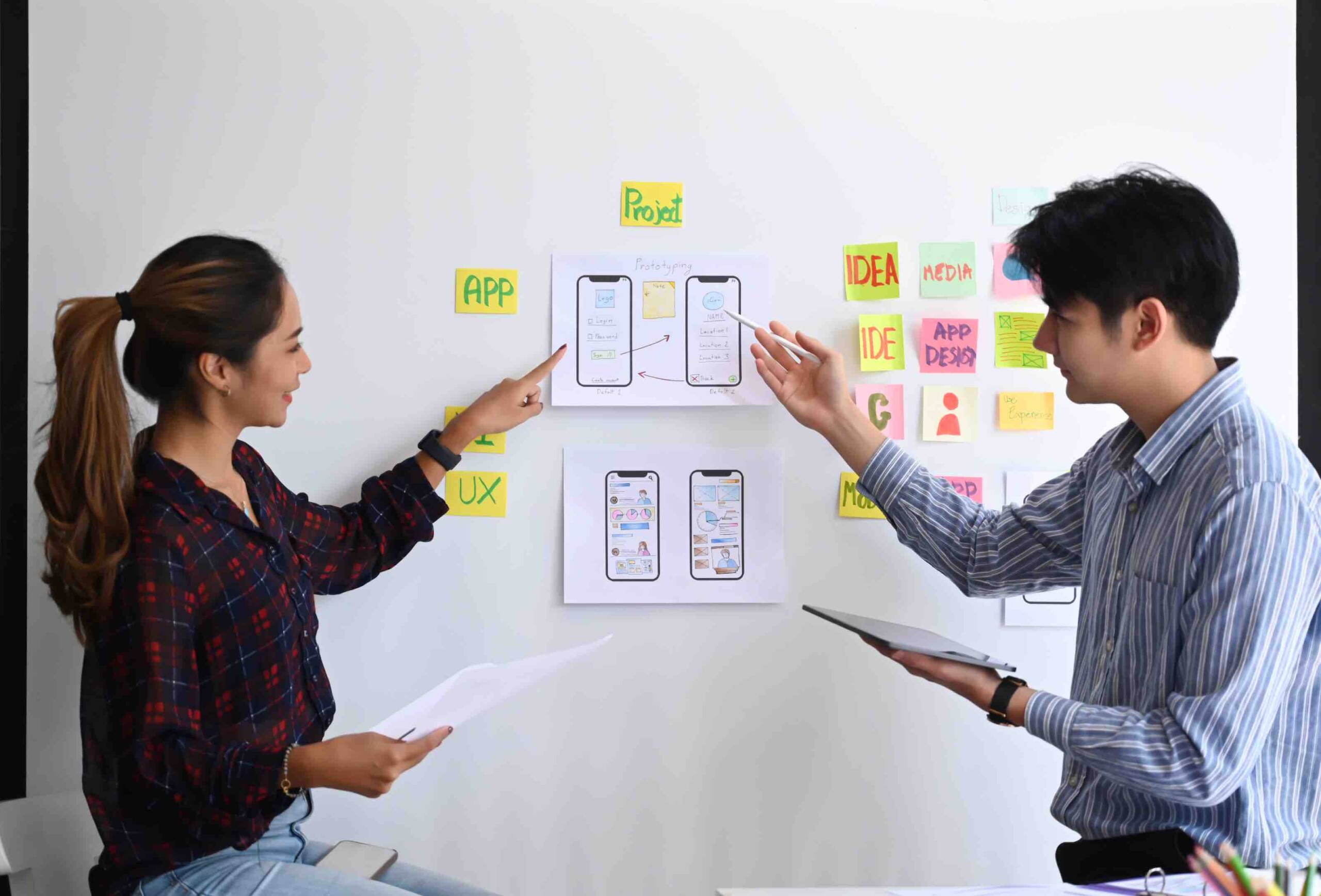 Two professional working on design board