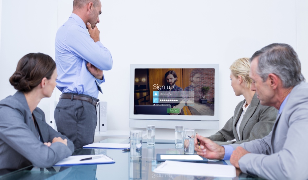 Four person looking on a computer screen displaying sing-up page