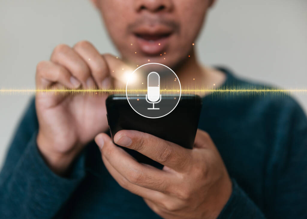 A man turning on mic on a smartphone