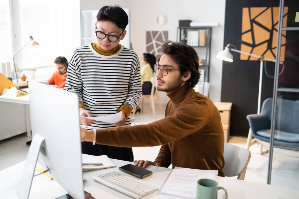 2 designers looking at a desktop 