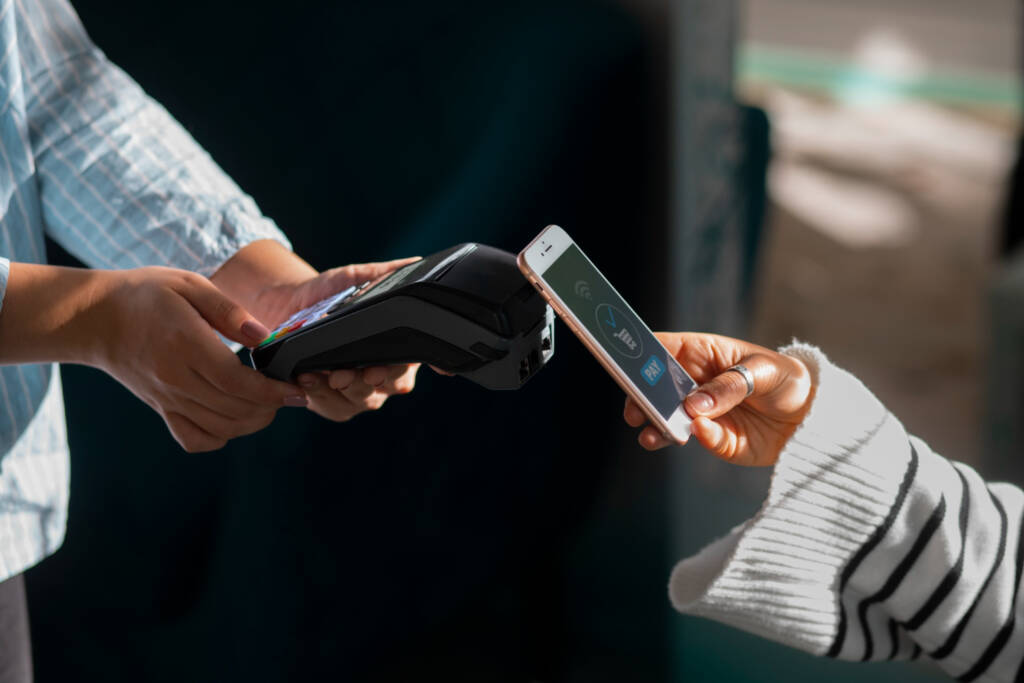 Person paying with NFC technology