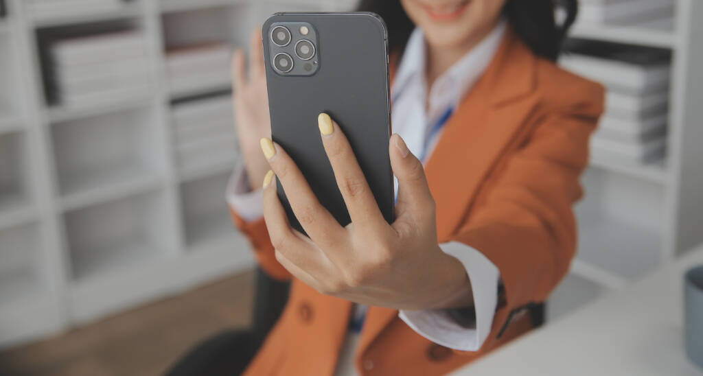 A woman taking selfie with gesture