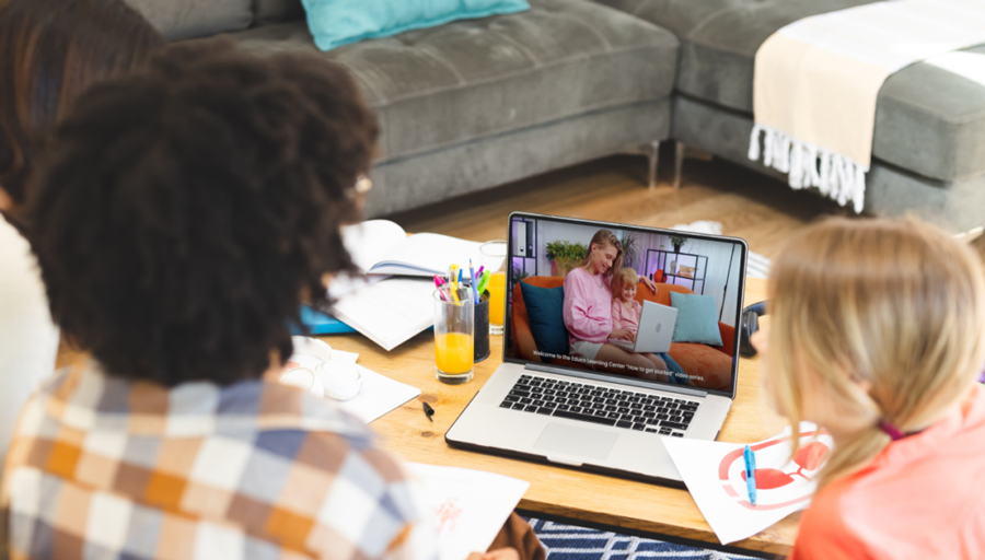 2 Students watching video on laptop at home