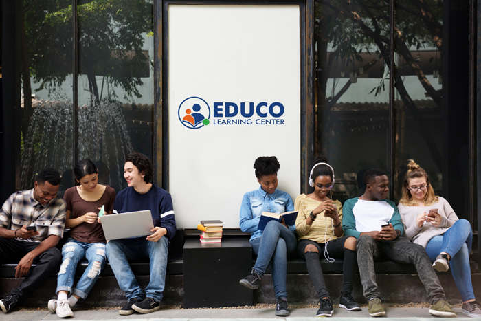 Diversed group of college student sitting near Educo Learning Center totem