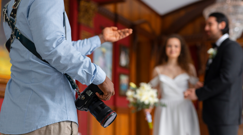 Photographer disscussing with couple for shoot