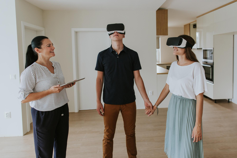 A smiling couple wearing VR sets explores property tours with a real estate agent