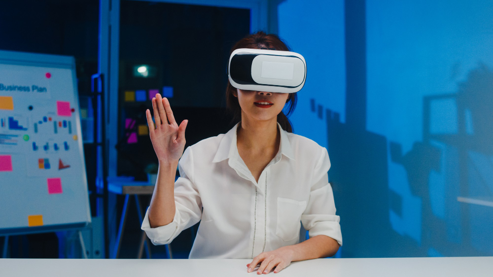 A girl in white shirt raising one hand is wearing a VR