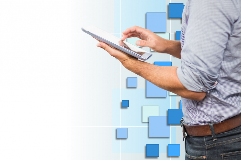 A man using his tablet with background in blue tones