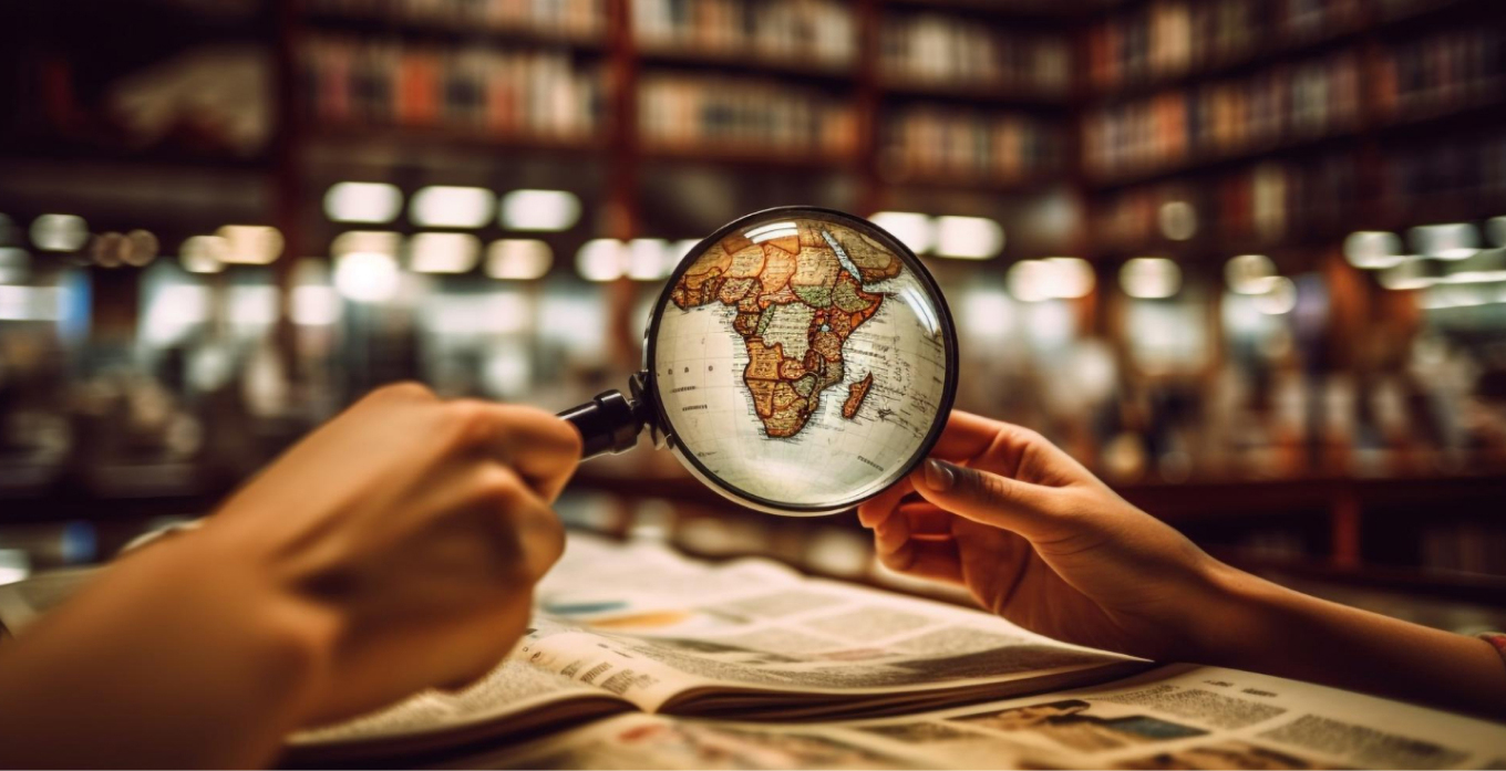 Someone is using magnifing glass to zoom in the world map