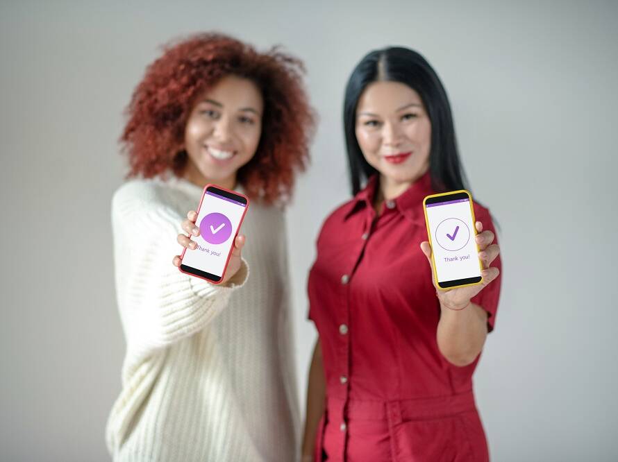 Friends holding smartphones while using social media
