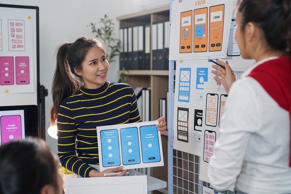 UX designers discussing user flow and behavior on app