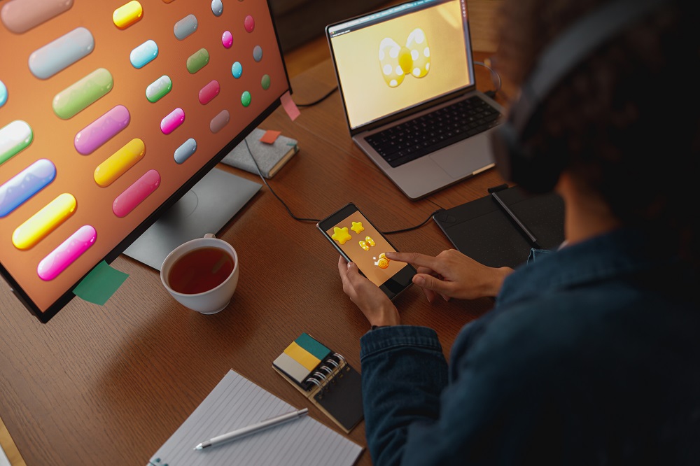 Woman graphic designer is using smartphone to design microinteractions