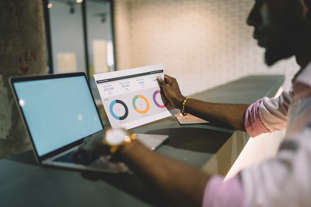 A man looking at Impact of good UX on a laptop