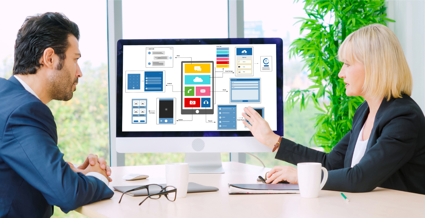 A lady and a man discussing wireframe on computer