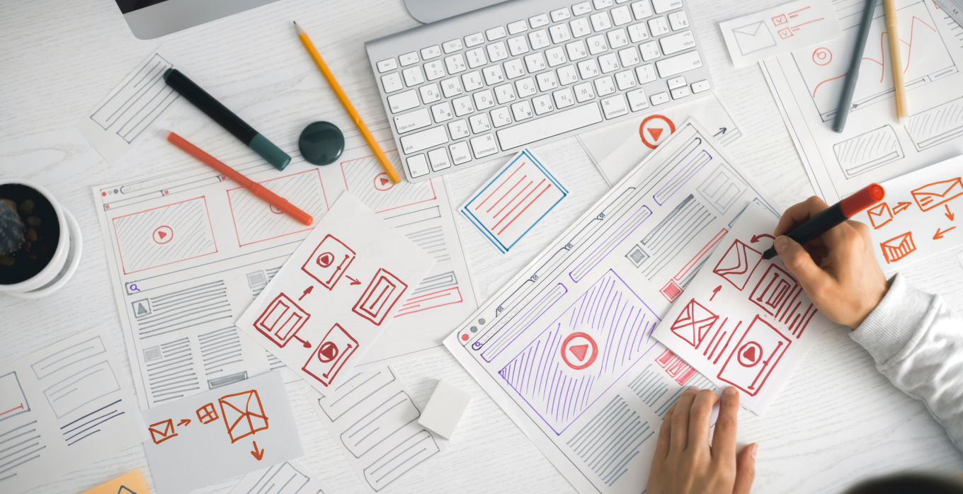 someone doing hand drawn wireframing