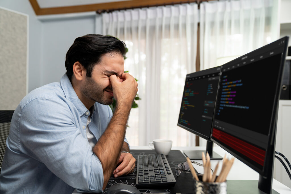 A stressful developer sitting near his computer