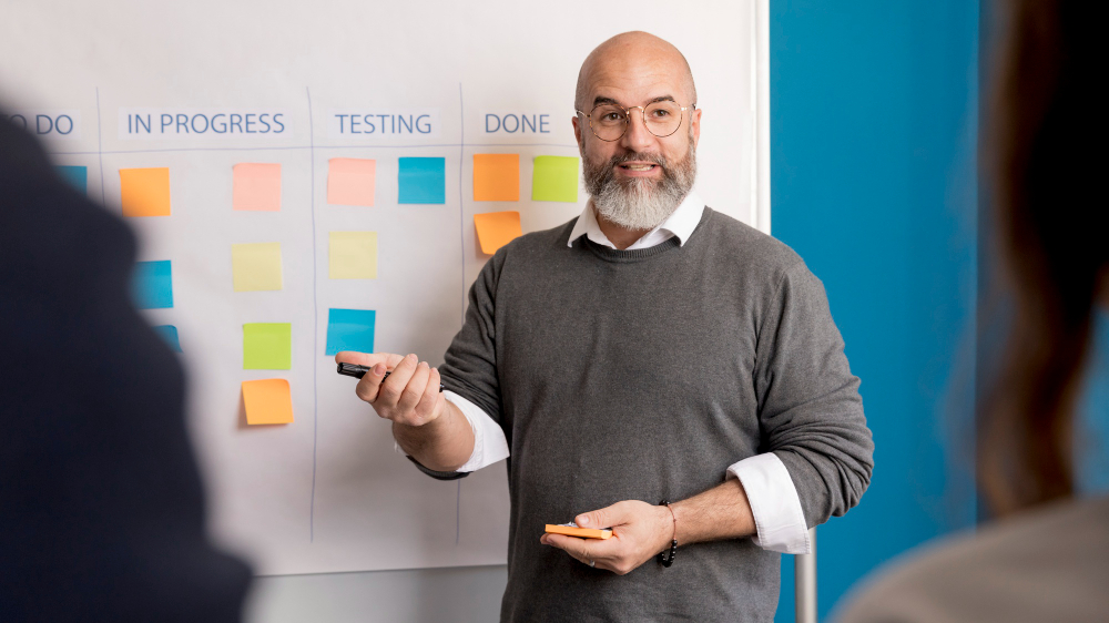 A designer standing near UX design board